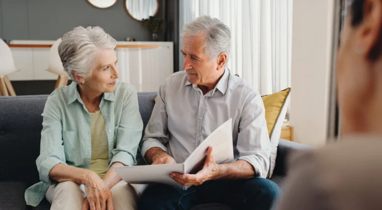 Senior and retired couple talking with finance documents in meeting with lawyer, planning retirement and will paperwork together in home. Mature man and woman in discussion about pension with advisor